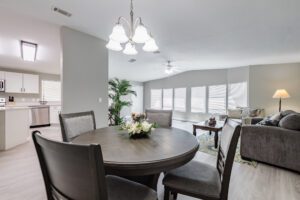 Modern dining and living room with furniture.