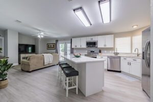 Modern kitchen and living room with island.