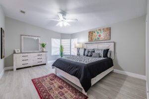 Modern bedroom with bed and dresser.
