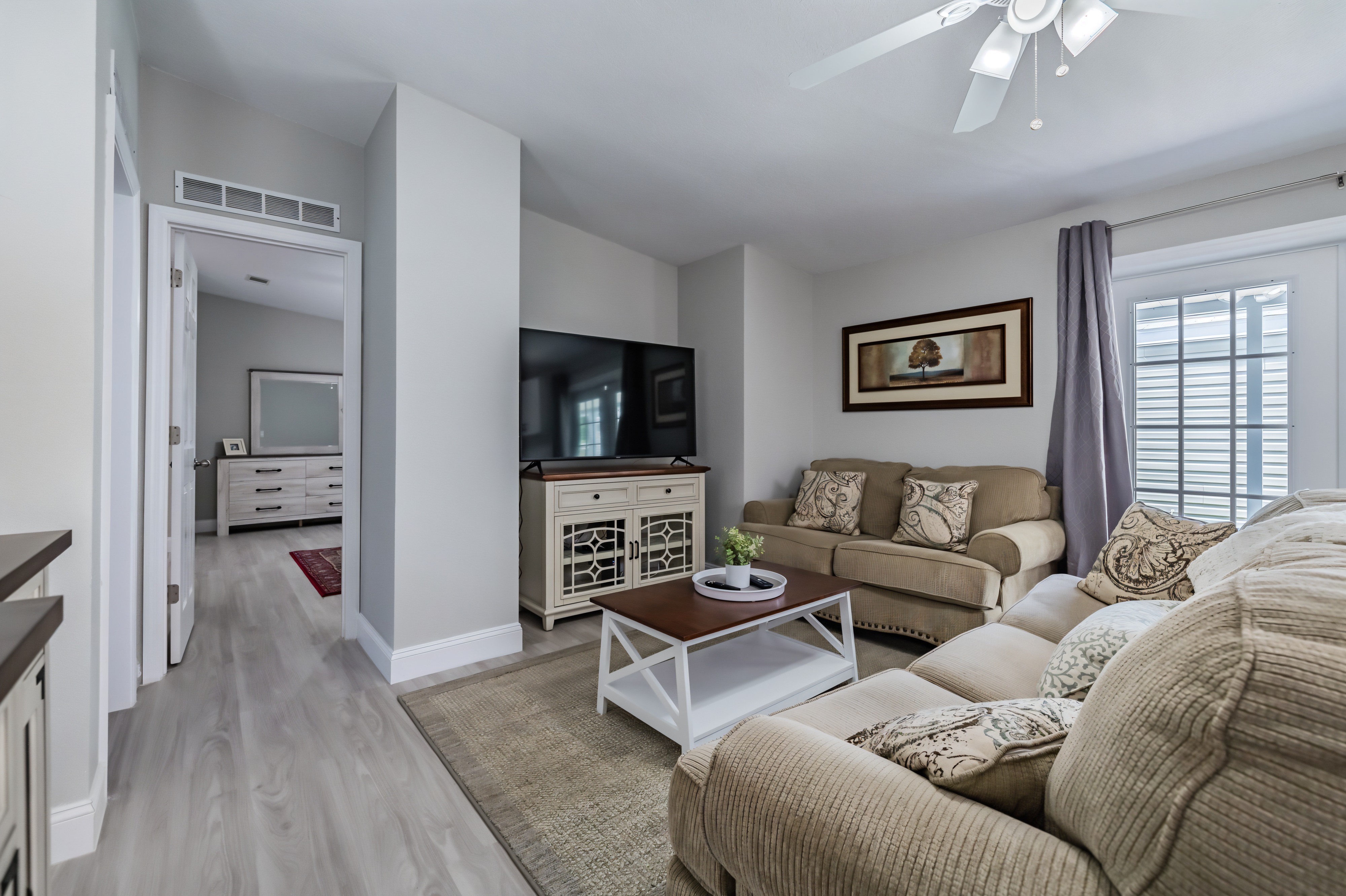 Cozy living room with beige sofas.