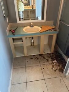 Bathroom sink under renovation with debris.