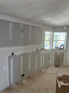 Unfinished room with drywall and window.